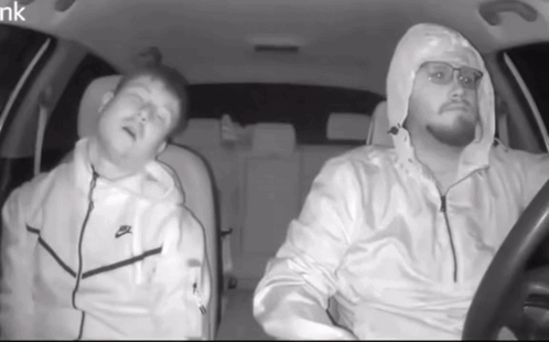 Man in White Nike Jacket Driving Car