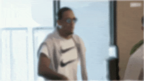 Man in White Nike Shirt and Sunglasses