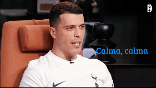 Man in White Nike Shirt Sitting in Orange Chair