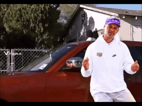 Man in White Nike Sweatshirt in Front of Red Car