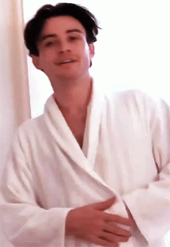 Man in White Robe Smiling at Camera