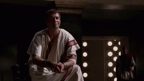 Man in White Robe With Red Stripe on Sleeves