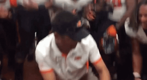 Man In White Shirt And Black Hat Dancing In Front Of Crowd GIF