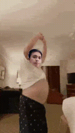 Man In White Shirt And Black Pants Stretching Arms GIF