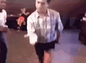 Man in White Shirt and Black Shorts Dancing