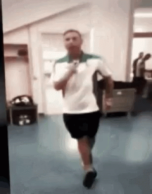 Man in White Shirt and Black Shorts Running