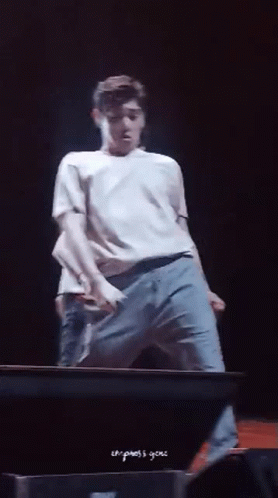 Man In White Shirt And Blue Jeans On Stage GIF