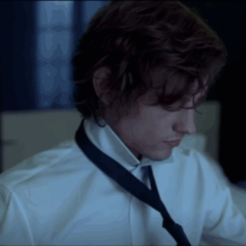 Man in White Shirt and Blue Tie Looking Down