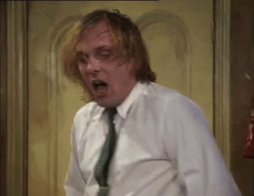 Man in White Shirt and Green Tie Surprised