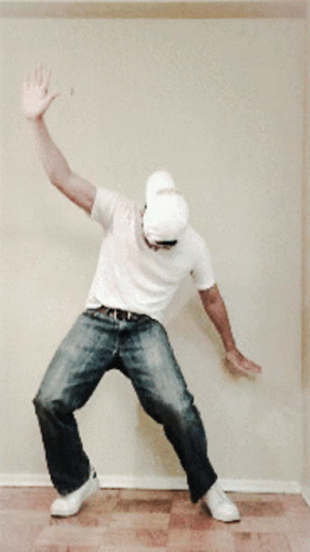Man in White Shirt and Hat Dancing
