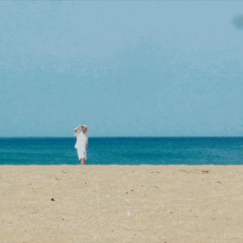 Man In White Shirt And Hat On Beach GIF