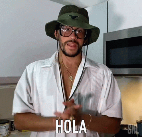 Man in White Shirt and Hat Says Hola