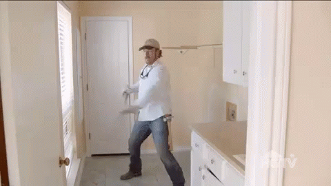 Man In White Shirt And Hat Standing In Room GIF