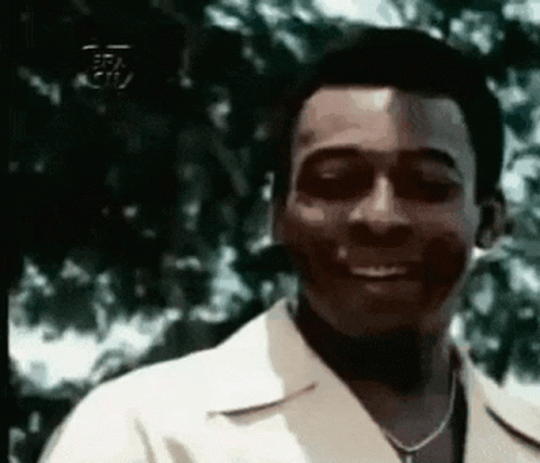 Man In White Shirt And Necklace Smiling GIF