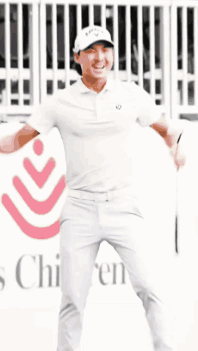 Man in White Shirt and Pants in Front of Children's Hospital Sign