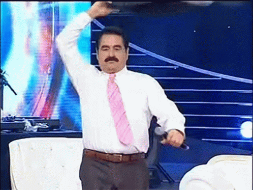 Man in White Shirt and Pink Tie Holding Microphone