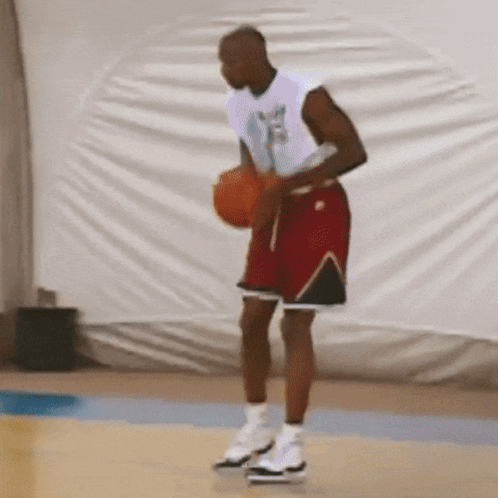 Man In White Shirt And Red Shorts Holding Basketball GIF
