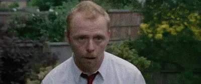 Man In White Shirt And Red Tie At Brick Wall GIF