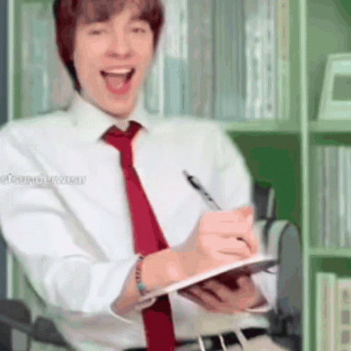 Man in White Shirt and Red Tie Writing on Clipboard