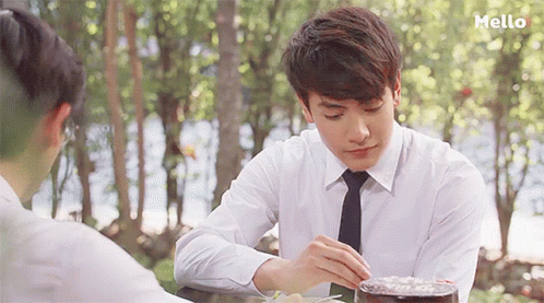 Man in White Shirt and Tie at Table