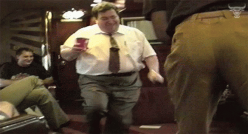 Man in White Shirt and Tie Dancing with Red Cup