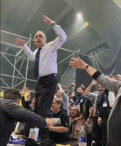 Man in White Shirt and Tie Dancing With Tob Sign