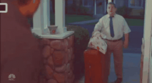Man In White Shirt And Tie In Front Of NBC Mailbox GIF