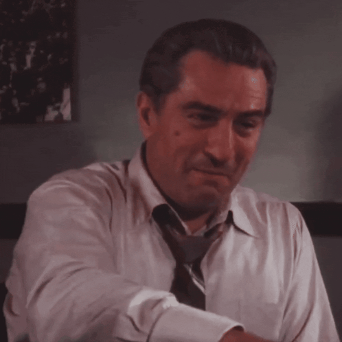Man in White Shirt and Tie Laughing
