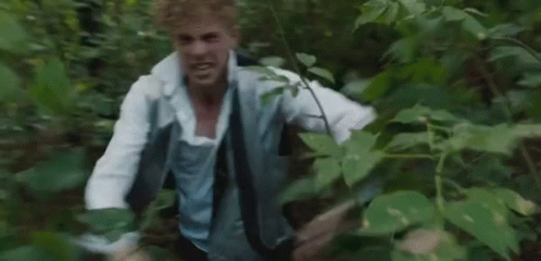 Man In White Shirt And Tie Running Through Forest GIF