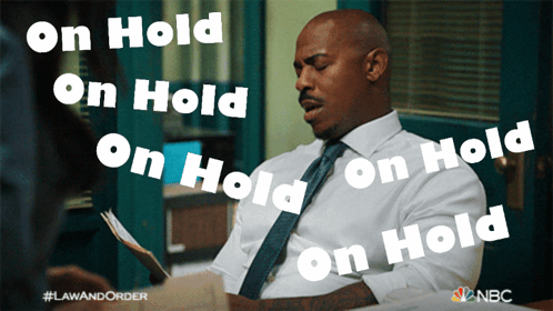 Man in White Shirt and Tie Saying On Hold