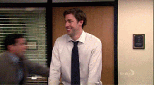 Man In White Shirt And Tie Standing By Window GIF
