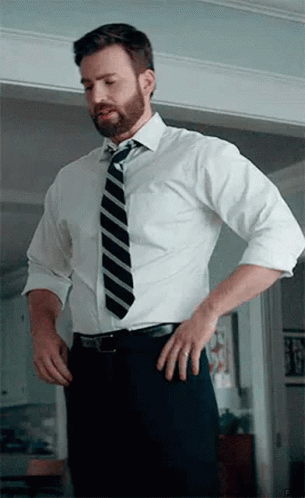 Man in White Shirt and Tie Standing in Doorway