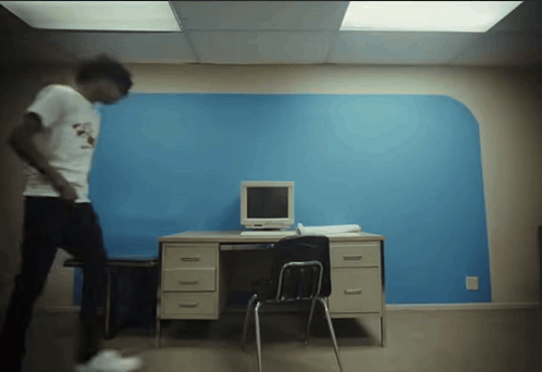 Man in White Shirt at Desk With Computer