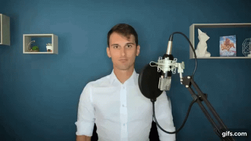Man in White Shirt at Microphone