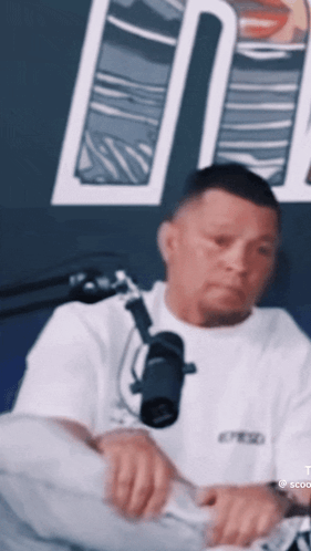 Man in White Shirt at Microphone