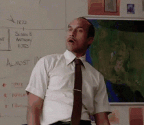Man in White Shirt at Whiteboard Saying Almost