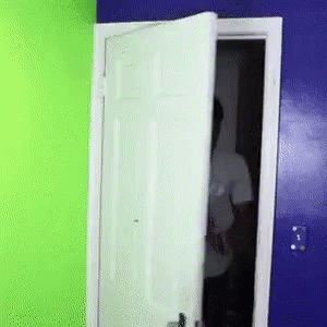 Man In White Shirt Behind Door GIF