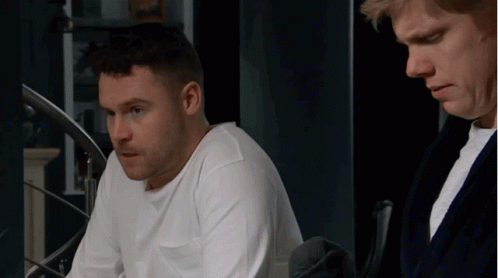 Man In White Shirt Beside Man In Black Robe GIF