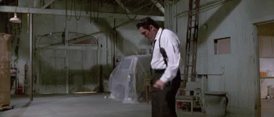 Man in White Shirt Black Pants Holding Gun