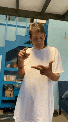 Man In White Shirt By Blue Stairs GIF