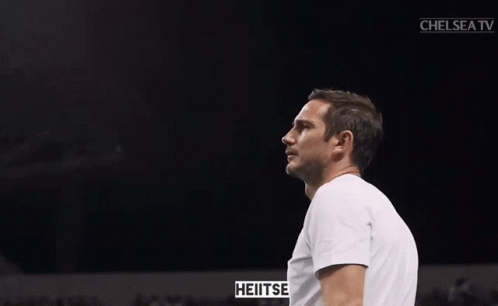 Man In White Shirt Clapping In Front Of Chelsea TV Screen GIF
