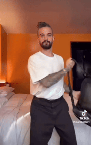 Man in White Shirt Dancing in Bedroom