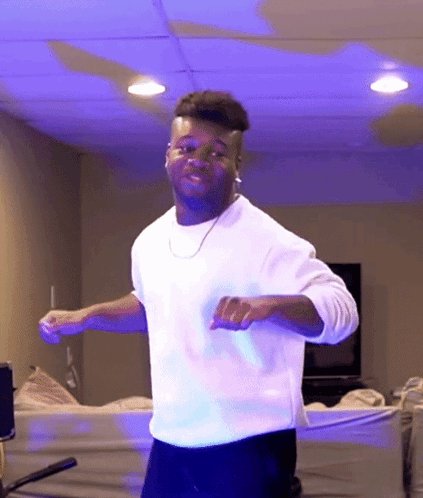 Man in White Shirt Dancing in Blue Light