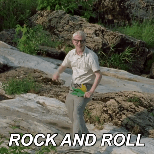 Man in White Shirt Dancing on Rock