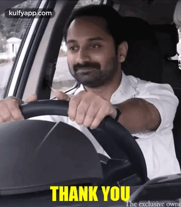 Man in White Shirt Driving Car Saying Thank You