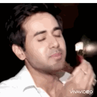 Man in White Shirt Eating with Spoon