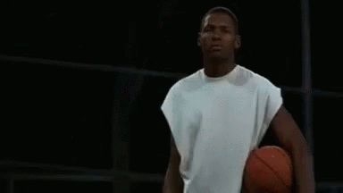 Man in White Shirt Holding Basketball