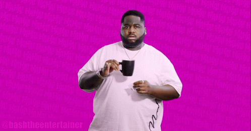 Man In White Shirt Holding Black Mug Says Bashthe Entertainer GIF