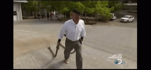 Man in White Shirt Holding Chain