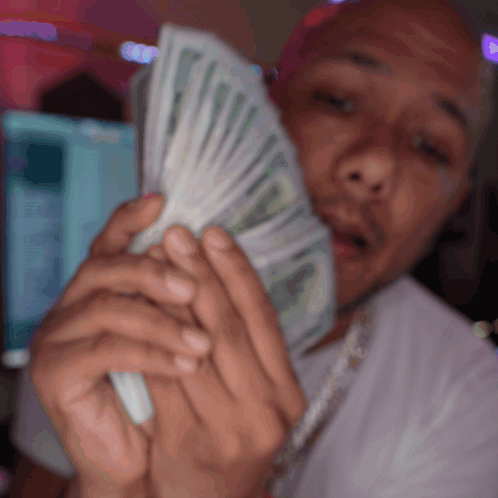 Man In White Shirt Holding Fan Of Money GIF